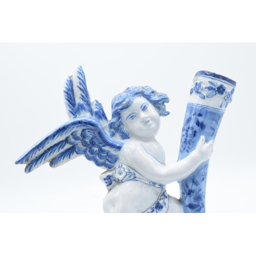 47 - English 19th century Delft model of a cherub holding a cornucopia in a tin glaze. Some chipping to t... 