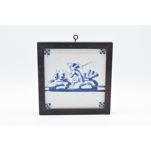 48 - 19th century framed blue and white Delft tile. There is some crazing and also some surface damage. 1... 