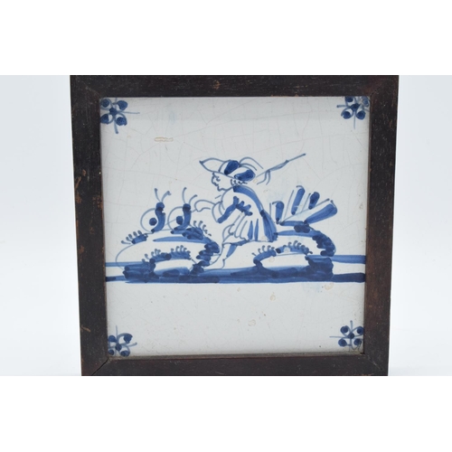 48 - 19th century framed blue and white Delft tile. There is some crazing and also some surface damage. 1... 