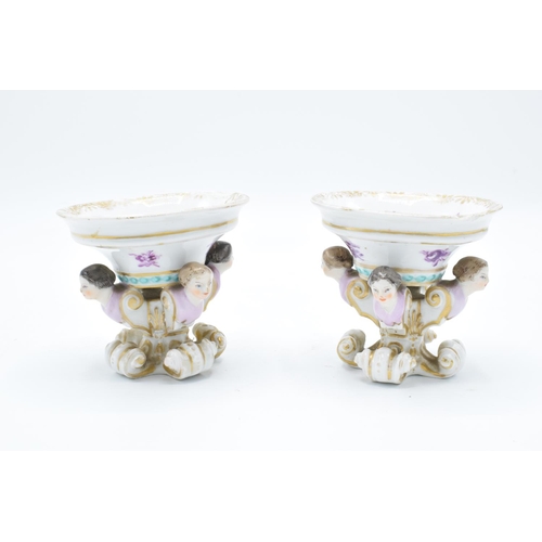 55 - Continental 19th century pair of trenchers with figural heads with a purple floral decoration. wear ... 