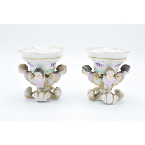 55 - Continental 19th century pair of trenchers with figural heads with a purple floral decoration. wear ... 