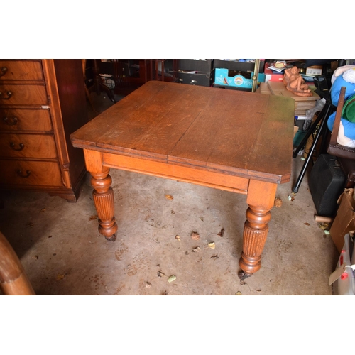 325 - Early 20th century golden oak dining table with a spare leaf and handle. In good condition with age ... 