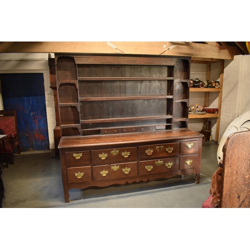 294 - Georgian large oak dresser with spice drawers: 4 draws wide. All original brass handles. Some damage... 