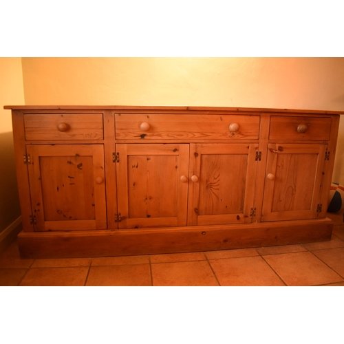 301 - 20th century pine sideboard with 3 draws and 4 doors. Signs of wear and tear and use in a family hom... 