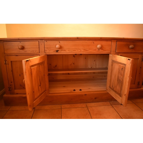 301 - 20th century pine sideboard with 3 draws and 4 doors. Signs of wear and tear and use in a family hom... 