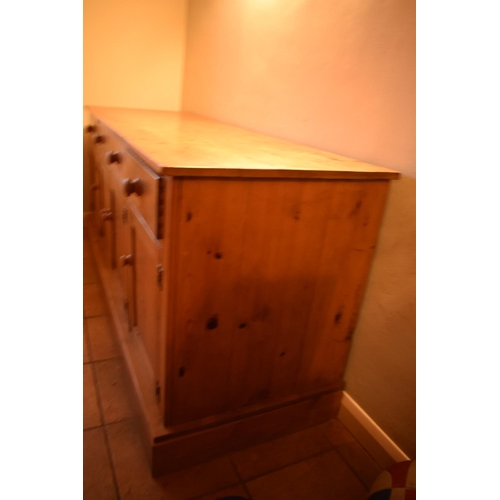 301 - 20th century pine sideboard with 3 draws and 4 doors. Signs of wear and tear and use in a family hom... 