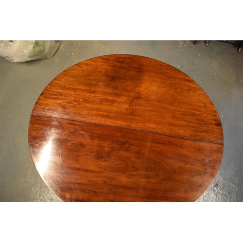 309 - Victorian mahogany circular dining table with one spare leaf. De-assembled. Sign of wear and tear. S... 