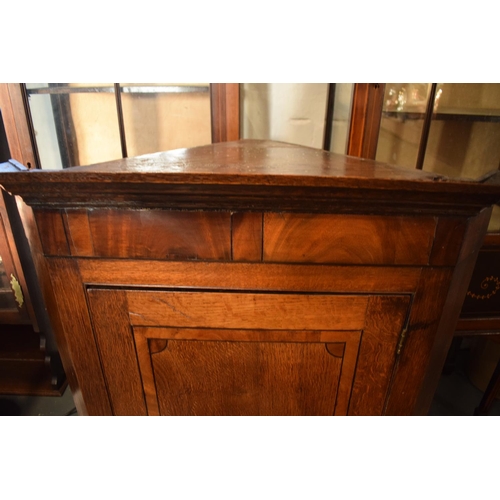 313 - Late Georgian oak inlaid corner cabinet with a bone escutcheon. Some wear and old worm is apparent. ... 