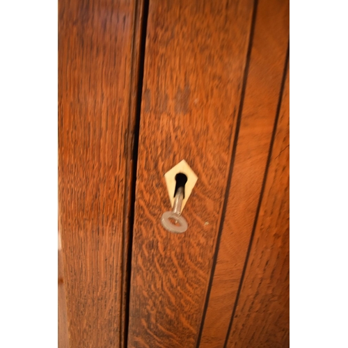 313 - Late Georgian oak inlaid corner cabinet with a bone escutcheon. Some wear and old worm is apparent. ... 