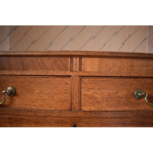 317 - Edwardian oak chest of drawers on caster wheels. There some splits to the wood and sections of missi... 