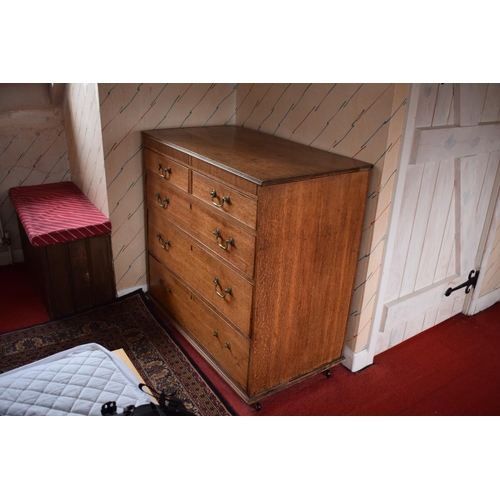 317 - Edwardian oak chest of drawers on caster wheels. There some splits to the wood and sections of missi... 