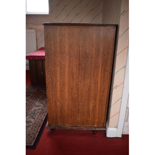 317 - Edwardian oak chest of drawers on caster wheels. There some splits to the wood and sections of missi... 