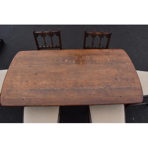 321 - Ercol elm dining table together with 6 matching chairs in a colonial style. Generally in good condit... 