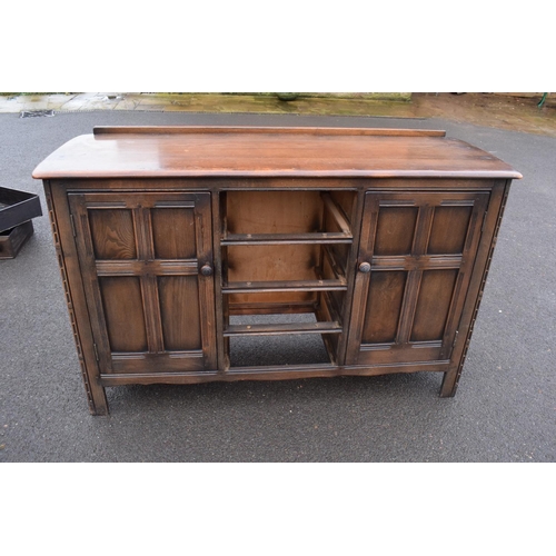 322 - Ercol dark elm sideboard with 2 doors and 4 drawers. In good functional condition with some areas of... 