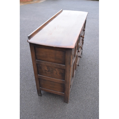 322 - Ercol dark elm sideboard with 2 doors and 4 drawers. In good functional condition with some areas of... 