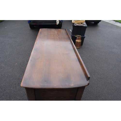 322 - Ercol dark elm sideboard with 2 doors and 4 drawers. In good functional condition with some areas of... 