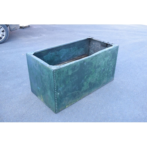 339 - Early 20th studded metal water trough which has been previously used as a planter. There have been h... 