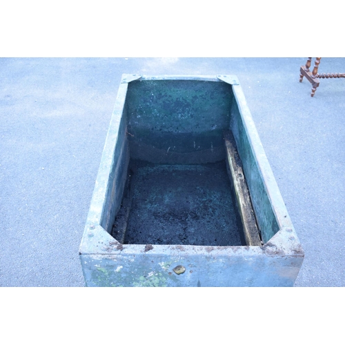 339 - Early 20th studded metal water trough which has been previously used as a planter. There have been h... 