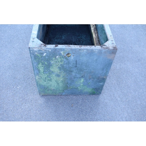 339 - Early 20th studded metal water trough which has been previously used as a planter. There have been h... 