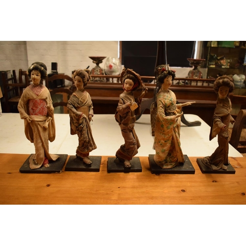 108 - A collection of 20th Japanese silk faced Geisha dolls (5). The dolls are I need of attention as they... 