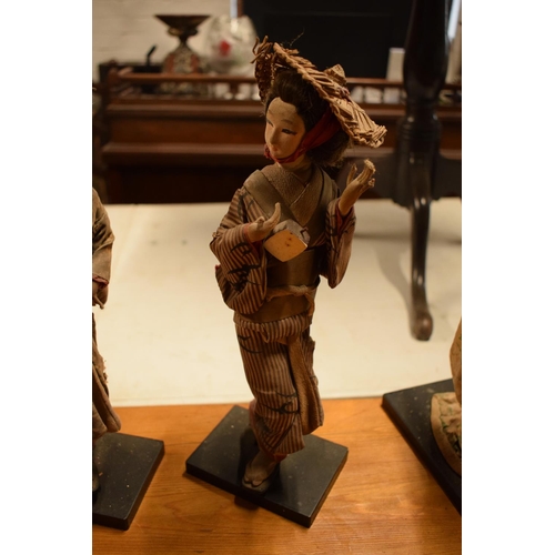 108 - A collection of 20th Japanese silk faced Geisha dolls (5). The dolls are I need of attention as they... 