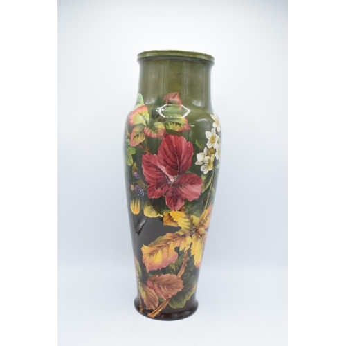 129 - Doulton Lambeth Faience vase with a floral design, initialled MW- Minnie Webb, 48cm tall. The item h... 