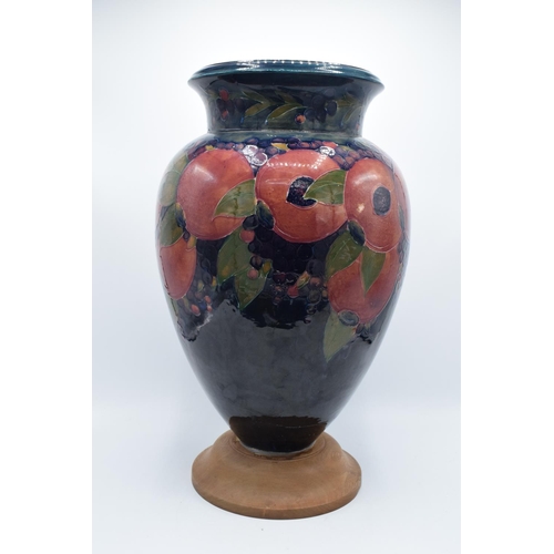 130B - Impressive Moorcroft bulbous vase in the Pomegranate design mounted on a newer wooden base. Standing... 
