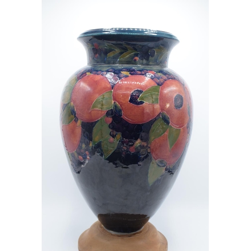 130B - Impressive Moorcroft bulbous vase in the Pomegranate design mounted on a newer wooden base. Standing... 