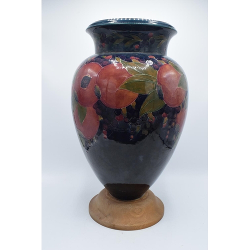 130B - Impressive Moorcroft bulbous vase in the Pomegranate design mounted on a newer wooden base. Standing... 