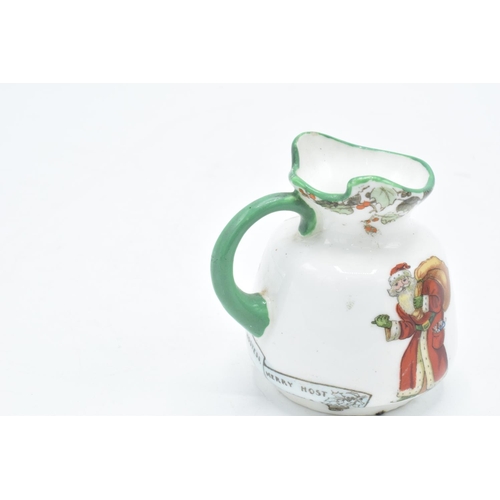 148 - Royal Doulton series ware to include a Father Christmas jug, a golfing scene vase ' He that always c... 