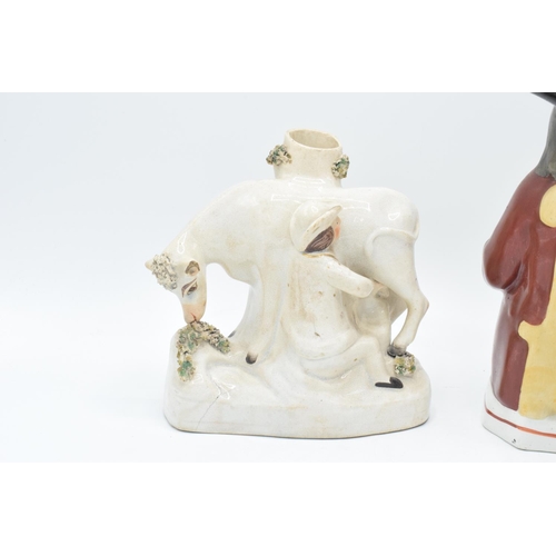 198 - 19th century Toby jug together with a cow spill vase (2). The spill vase has been damaged with chips... 