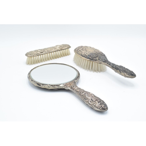 203 - A silver dressing table set to include a mirror, brush and hair brush hallmarked for 1920, we think ... 