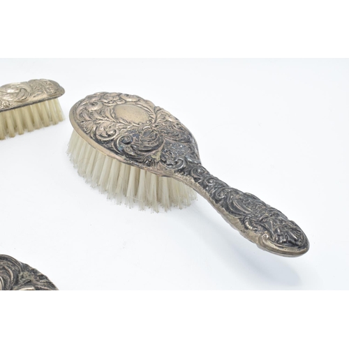 203 - A silver dressing table set to include a mirror, brush and hair brush hallmarked for 1920, we think ... 