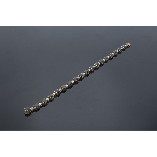 217 - 10k gold coloured metal sapphire & diamond bracelet: Tested as solid 9ct gold or better, set with 18... 