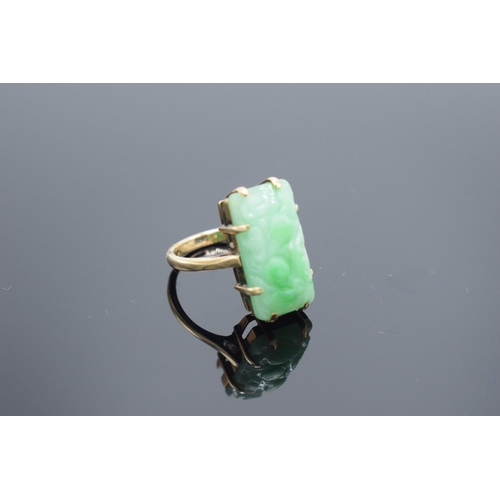 239 - 9ct gold carved jade ring, gross weight 5.1 grams.