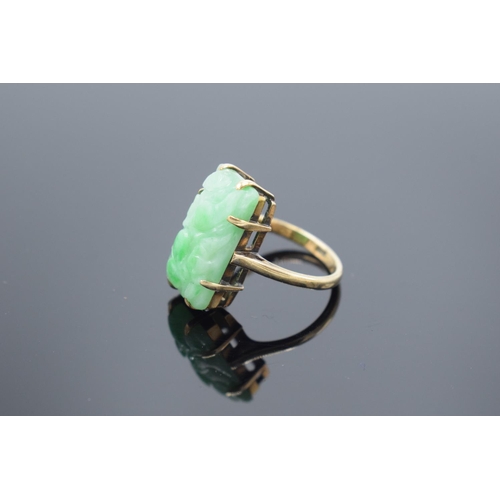 239 - 9ct gold carved jade ring, gross weight 5.1 grams.