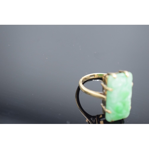 239 - 9ct gold carved jade ring, gross weight 5.1 grams.