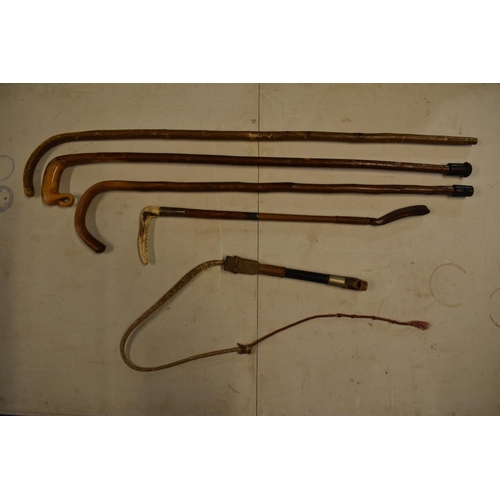 301 - A collection of sticks to include a riding crop, a horn dog whistle etc. Some damages.