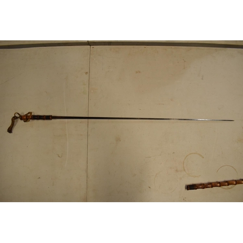 302 - Victorian bamboo trefoil fullered sword stick. Some tape repairs to the top of the items. Unmarked. ... 