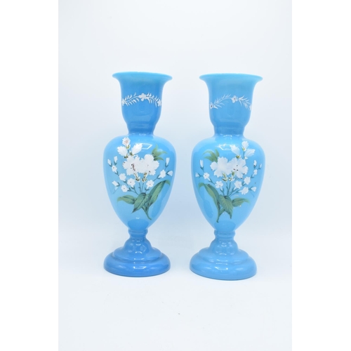 54 - A pair of large blue painted glass vases with floral scenes. In good condition with no obvious damag... 