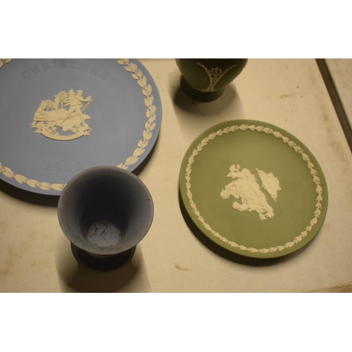 64 - A collection of Wedgwood Jasperware including a framed dip blue lid, plates vases etc (9)