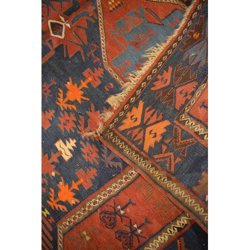 96 - Large 20th century wall hanging believed to be a  Persian Qashqai carpet with four blue ground lozen... 