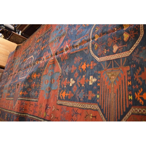 96 - Large 20th century wall hanging believed to be a  Persian Qashqai carpet with four blue ground lozen... 