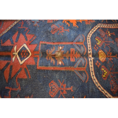 96 - Large 20th century wall hanging believed to be a  Persian Qashqai carpet with four blue ground lozen... 