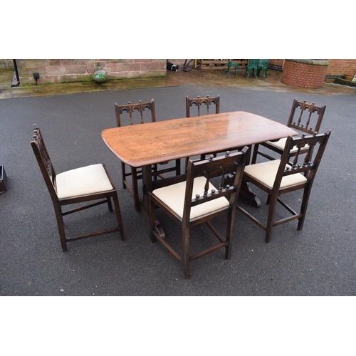 345 - Ercol elm dining table together with 6 matching chairs in a colonial style. Generally in good condit... 