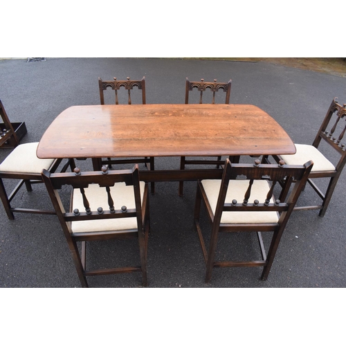 345 - Ercol elm dining table together with 6 matching chairs in a colonial style. Generally in good condit... 