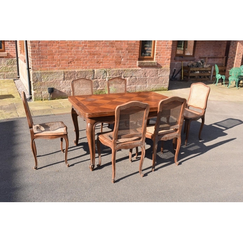 358 - Edwardian extending table together with 6 wicker-style back dining chairs (7). The table is in good ... 