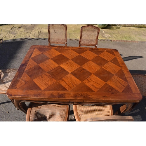 358 - Edwardian extending table together with 6 wicker-style back dining chairs (7). The table is in good ... 