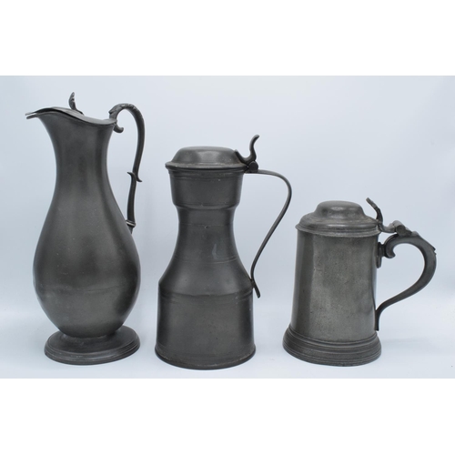 21 - Early 19th century pewter to include a flagon, a jug and a lidded tankard (3) As expected. Flagon ha... 