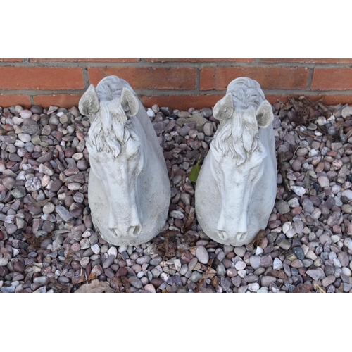 253 - Reconstituted stone pair of horses heads. 35cm tall. 

Made in England, these items are frost and we... 